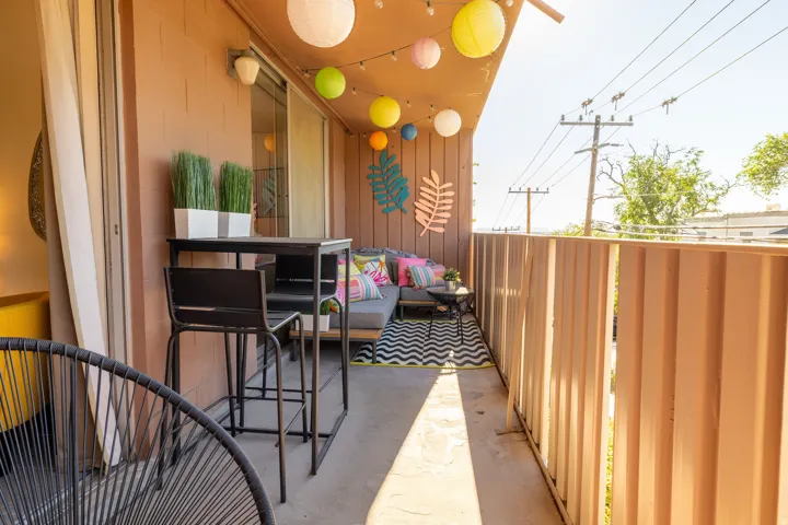 Private outdoor balcony with a sliding glass door and durable concrete flooring