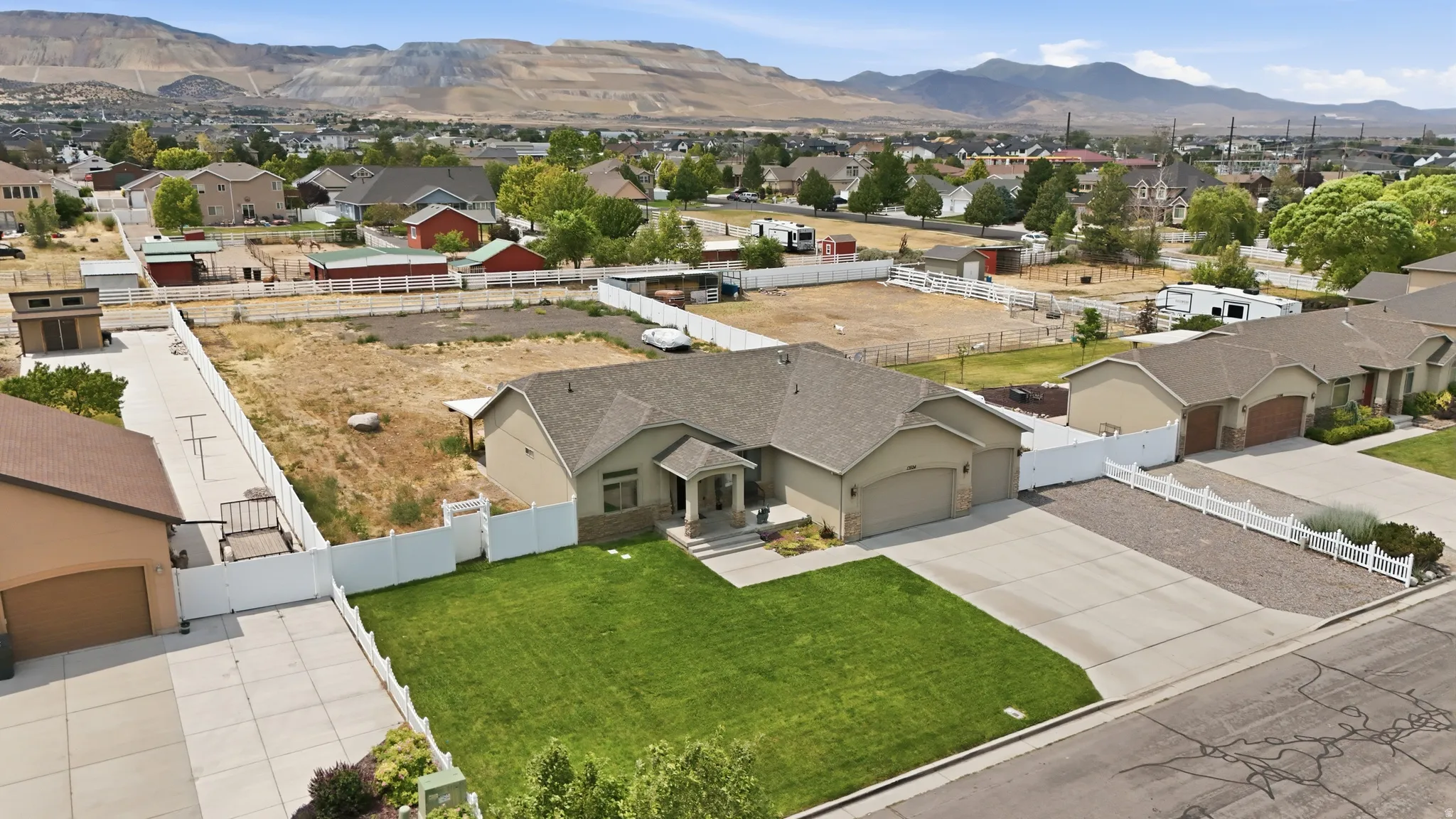 Single-story residence featuring an attached two-car garage, concrete driveway, and a front lawn