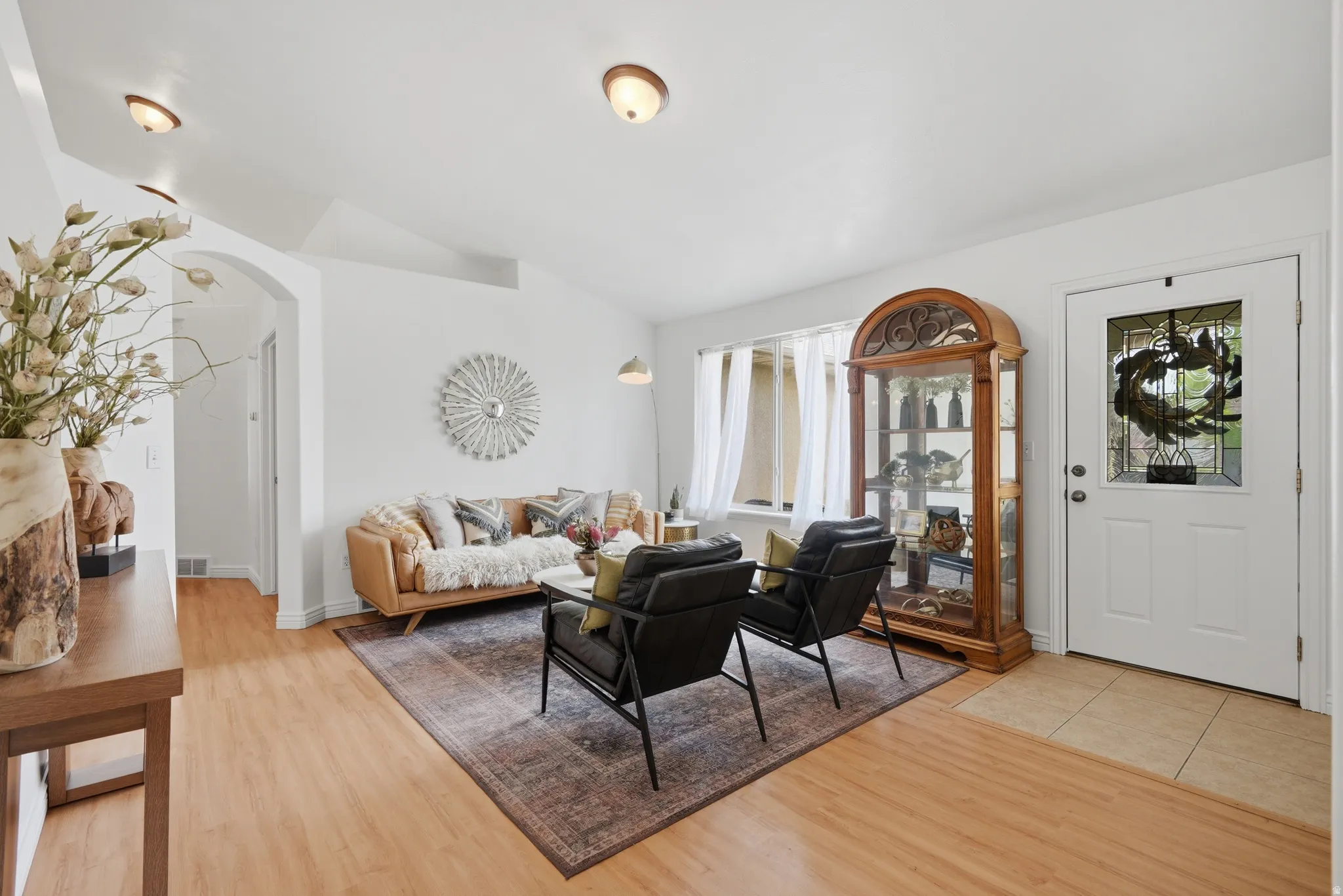 Open living area with light wood-finish flooring and vaulted ceilings
