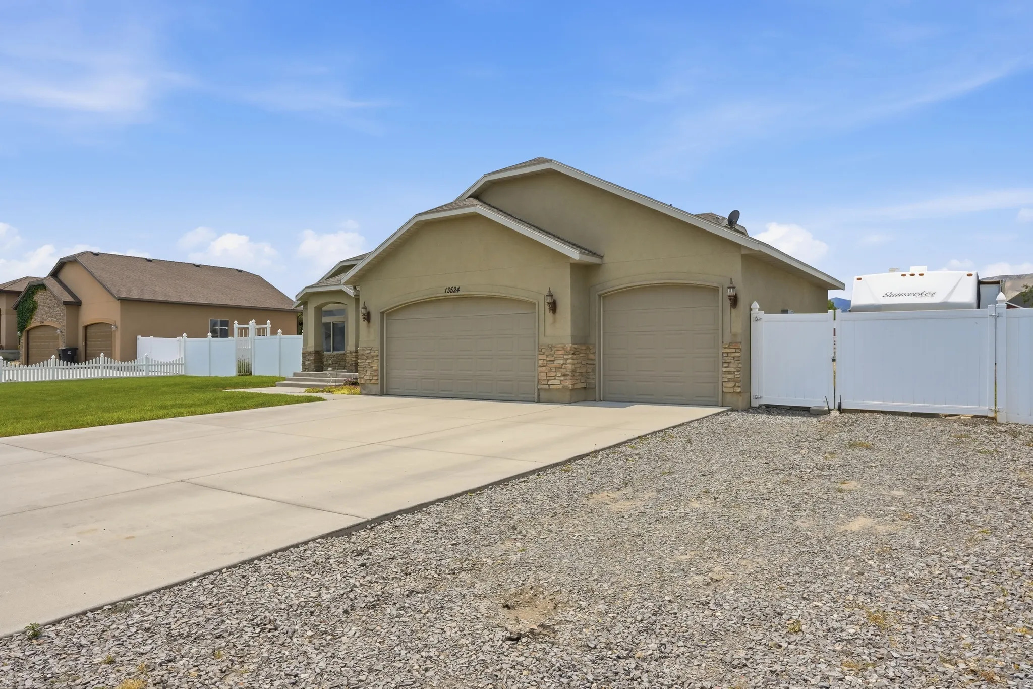 Stucco exterior with stone accents and two attached garage doors