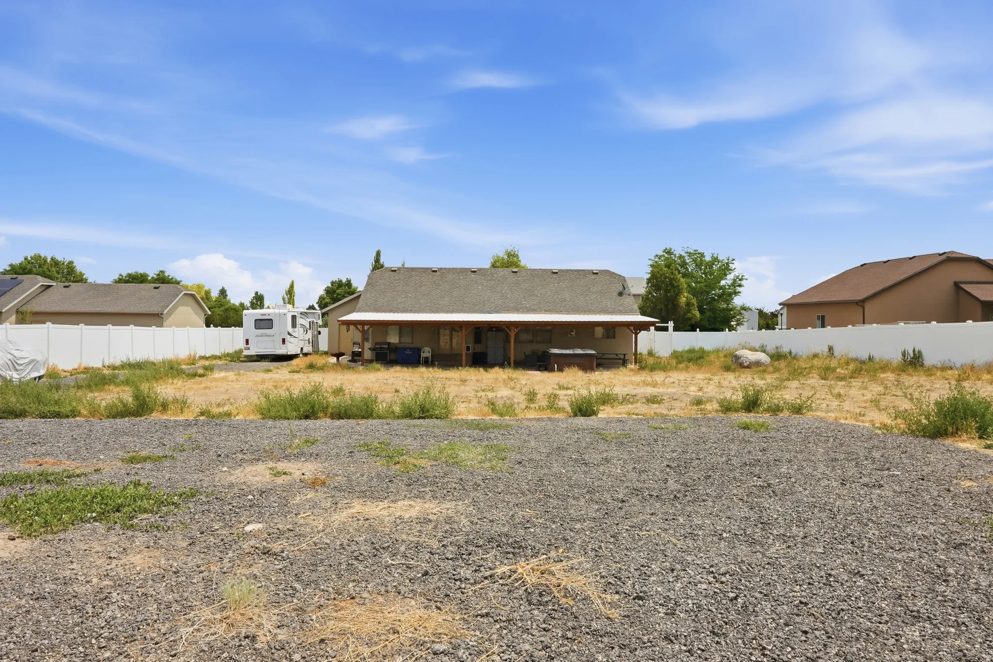 Expansive gravel and dirt lot, offering significant undeveloped space