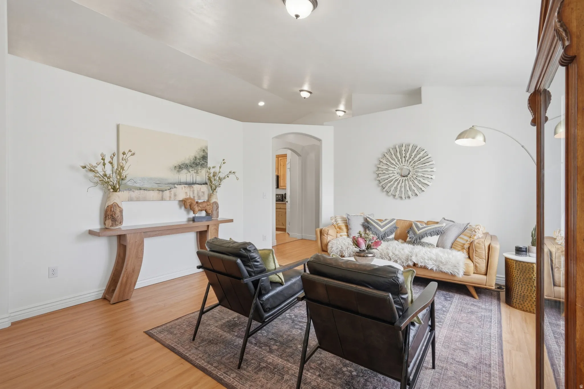 Living area with wood-finish flooring, white baseboards, and recessed lighting