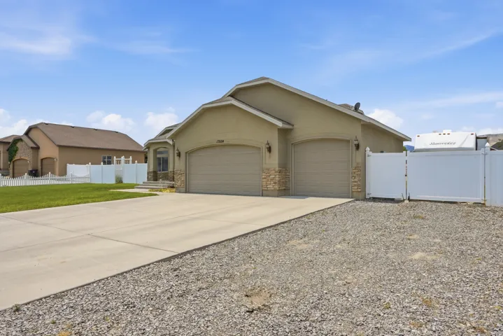 Stucco exterior with stone accents and two attached garage doors
