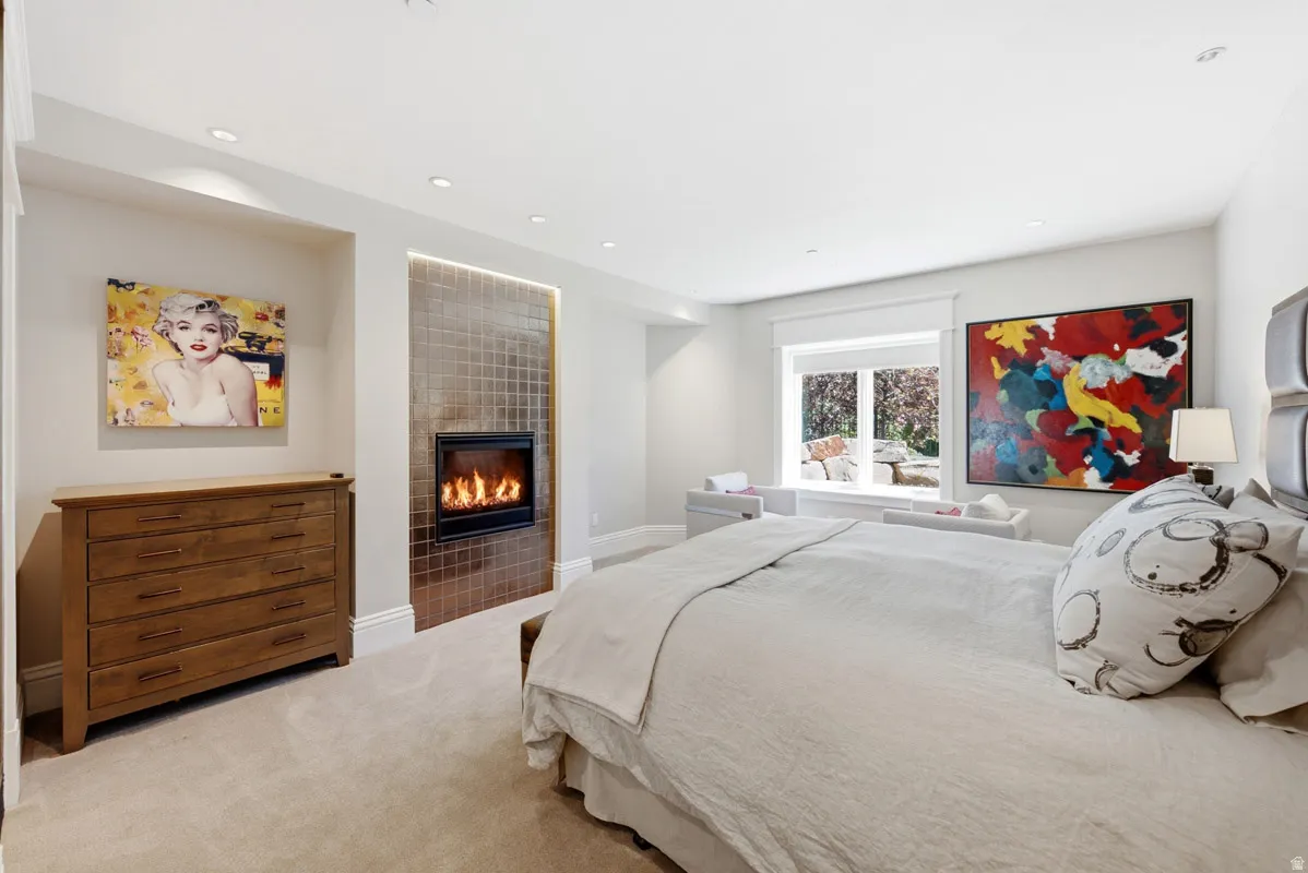 Recessed electric fireplace with a tiled surround and accent lighting