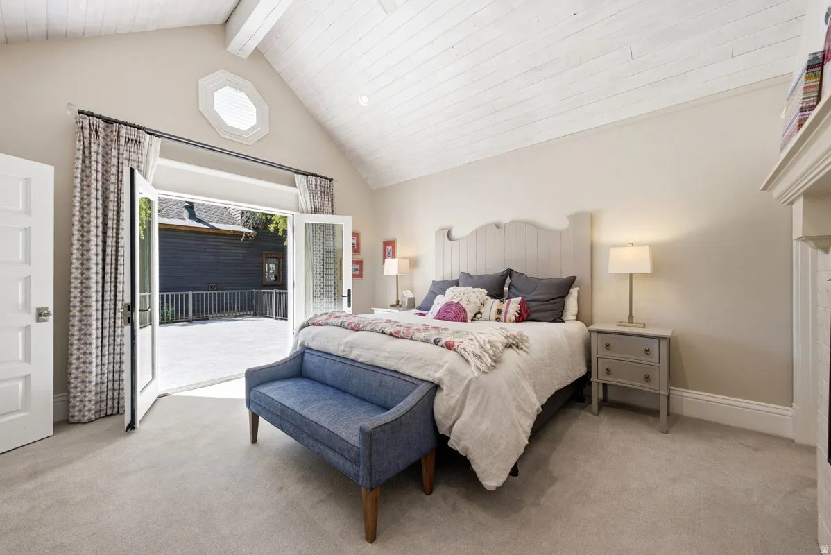Vaulted white wood-paneled ceiling with exposed beams