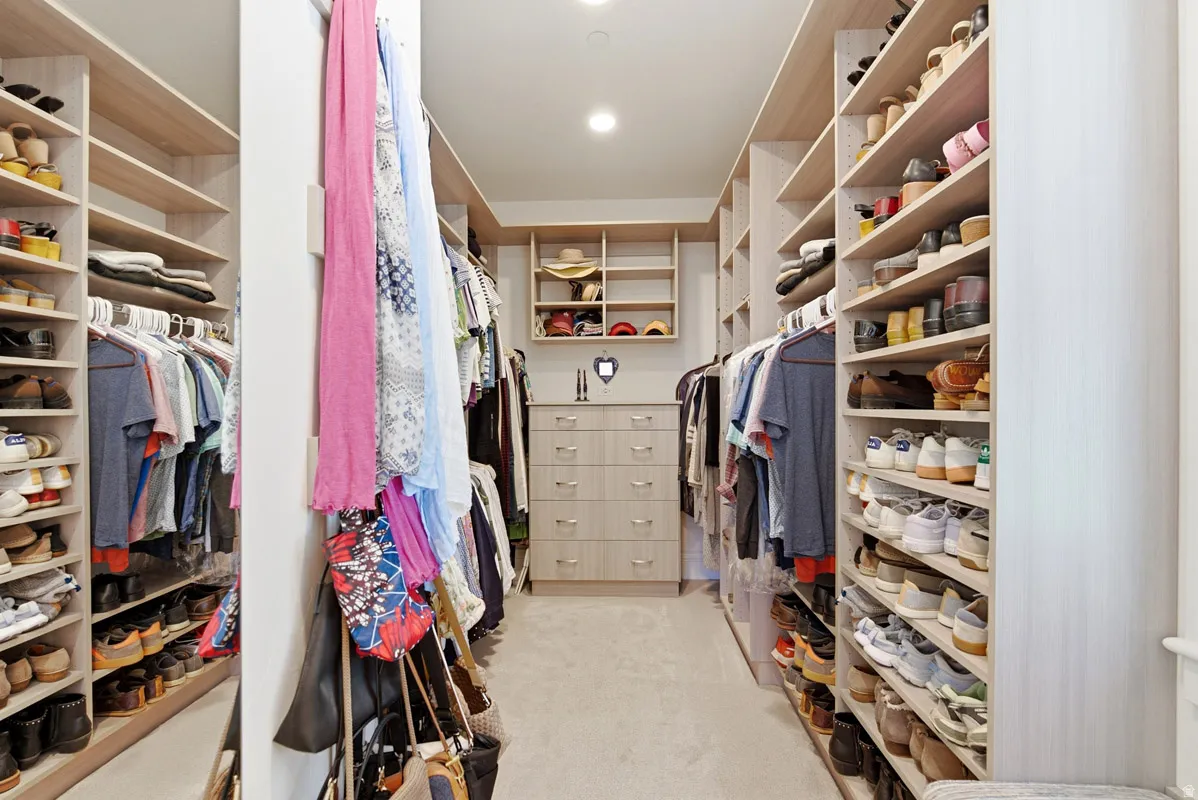 Custom closet system featuring extensive shelving and hanging rods