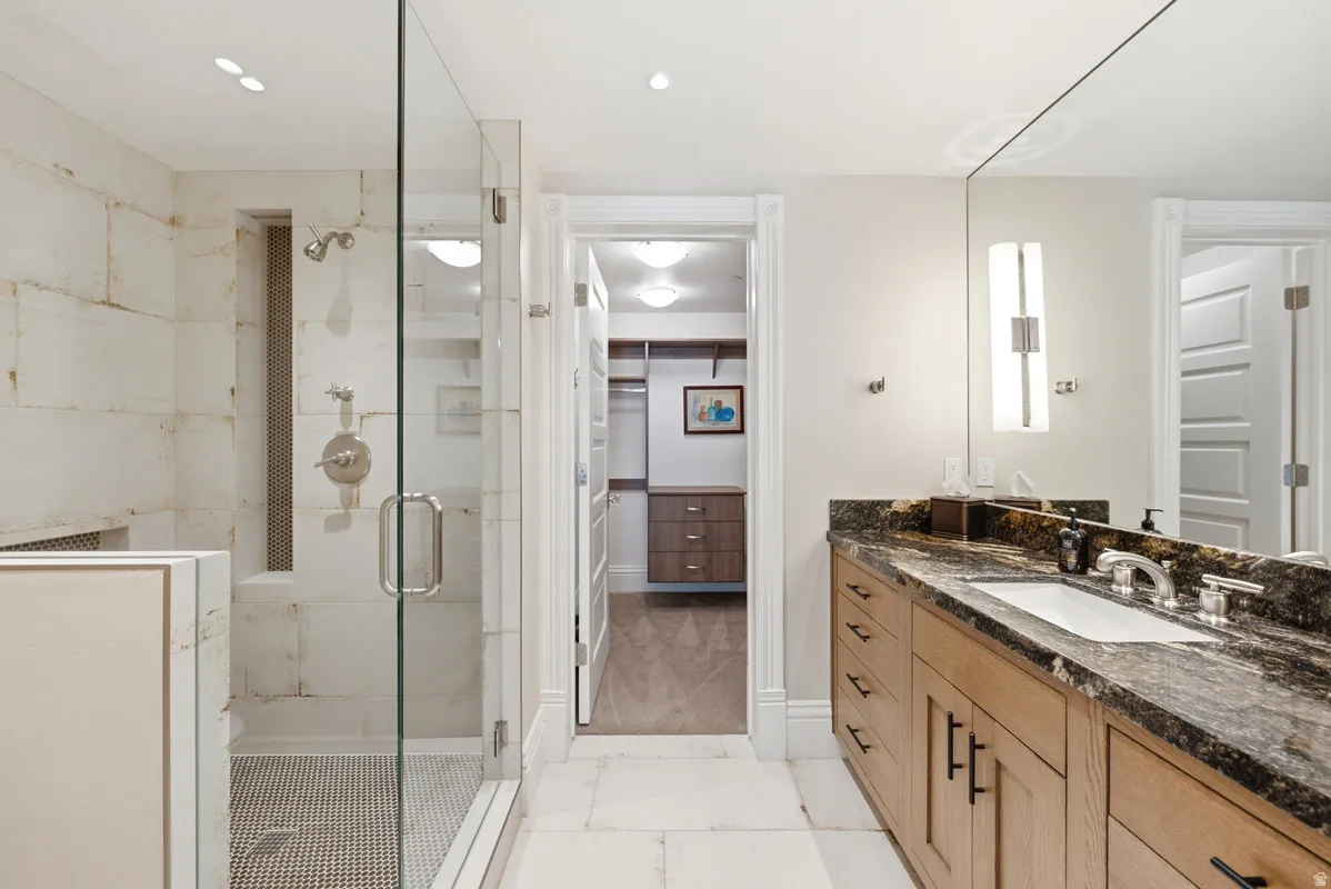 Glass-enclosed shower with tiled walls and a built-in niche