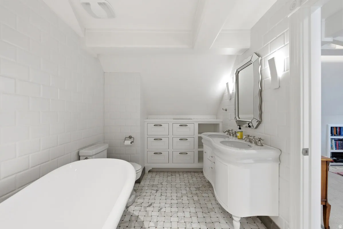 White subway tile walls with a classic freestanding tub