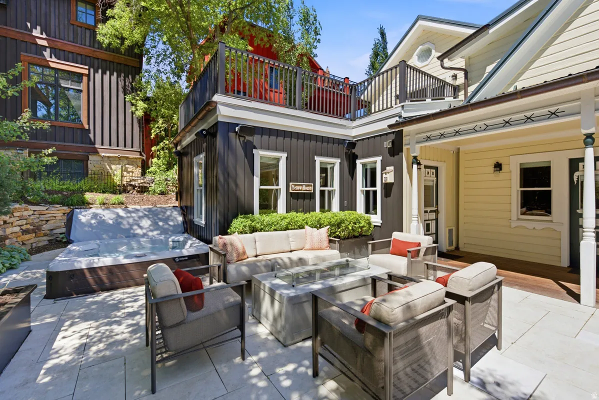 Expansive stone patio featuring a built-in spa