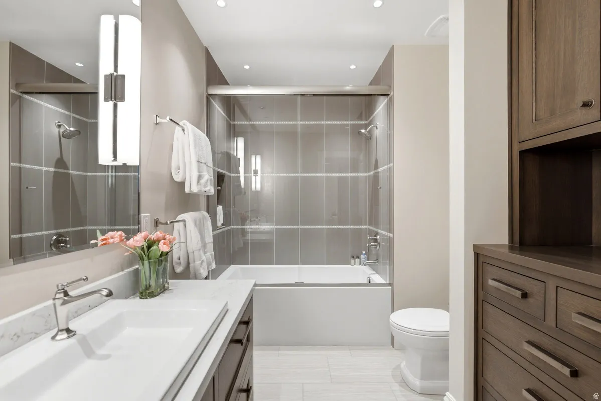 Contemporary bathroom featuring a combined shower and soaking tub with full-height tile surround