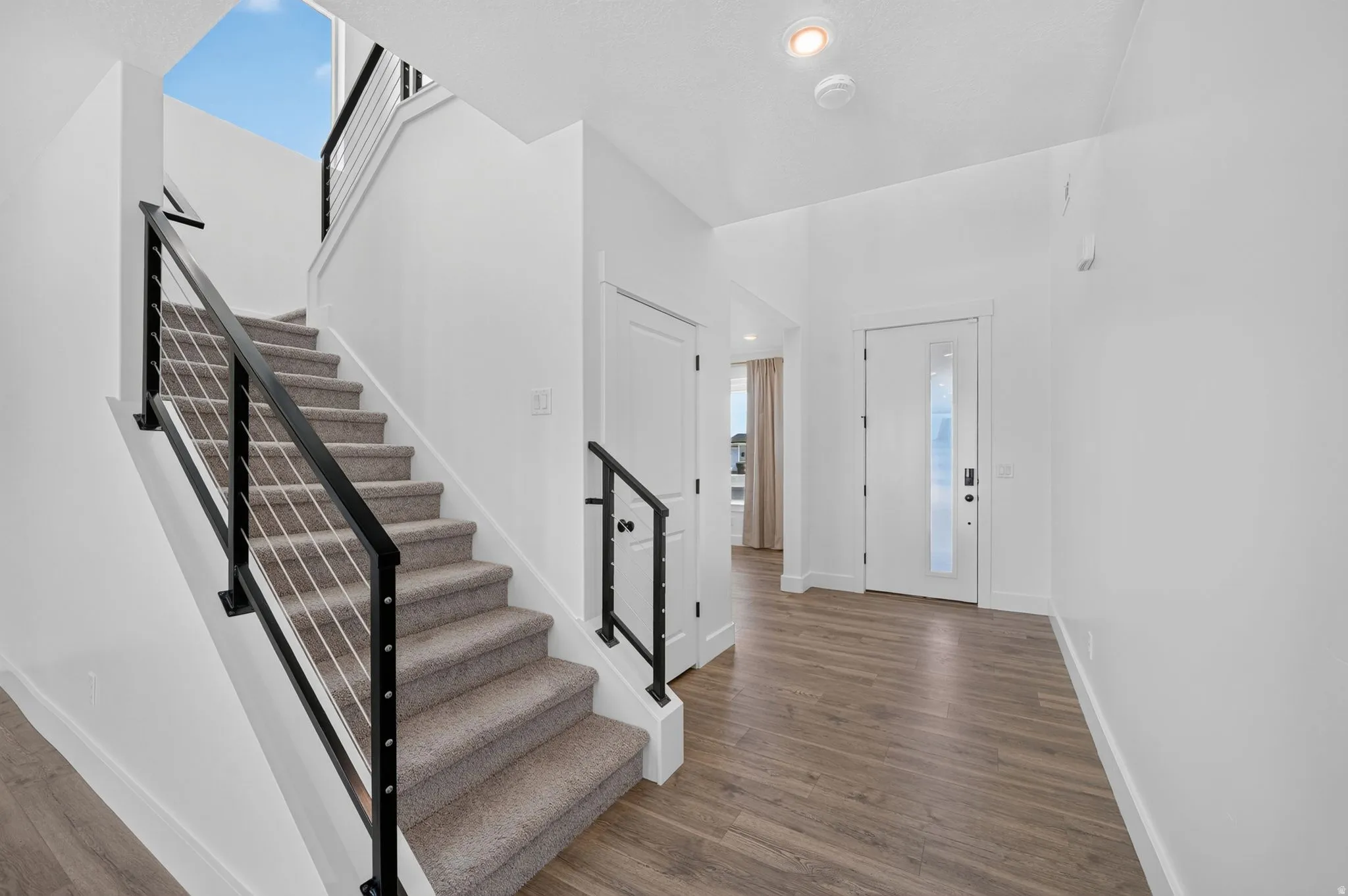 Staircase with cable railing system and carpeted treads