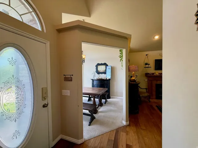 Entryway featuring an ornate oval glass door with an arched transom window