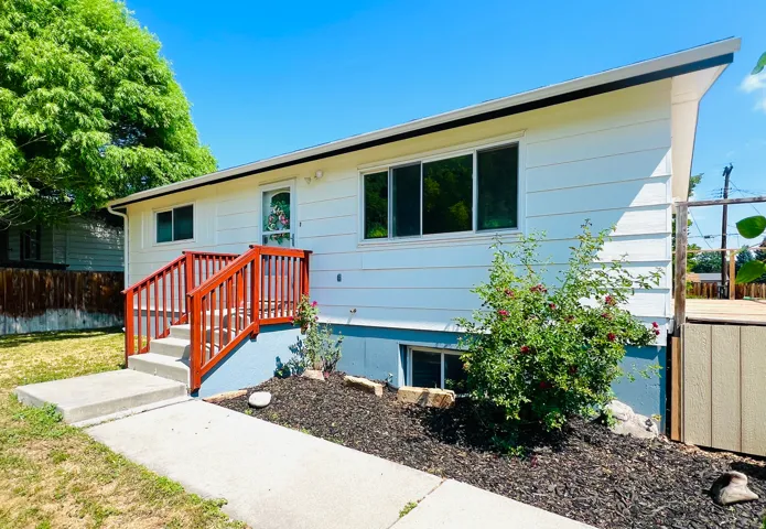 White siding exterior with a contrasting blue foundation