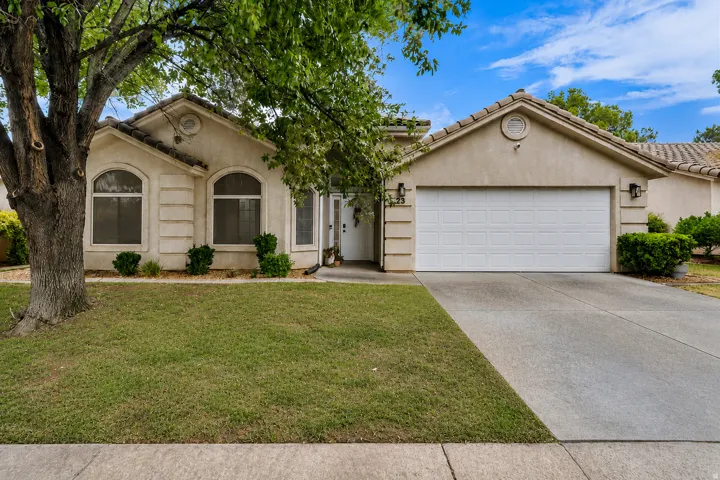 Stucco exterior with an attached garage and a concrete driveway