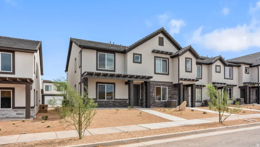 Modern townhome exterior with stucco siding and dark trim accents
