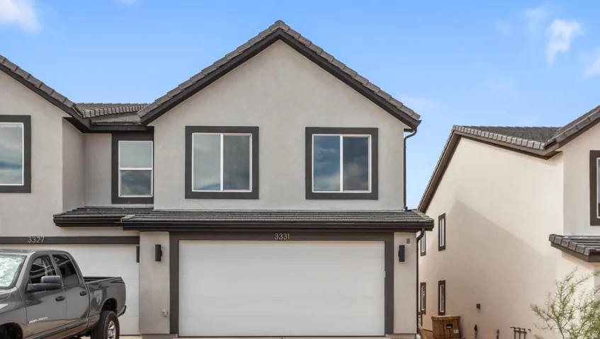 Contemporary stucco exterior with dark trim accents and a two-car garage