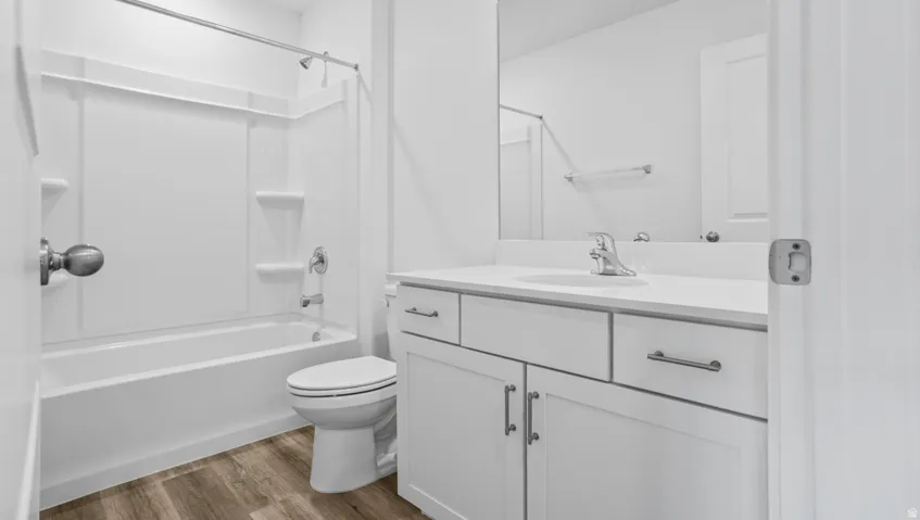 Bathroom featuring a white vanity with a light-toned countertop, a rectangular undermount sink, and a chrome faucet