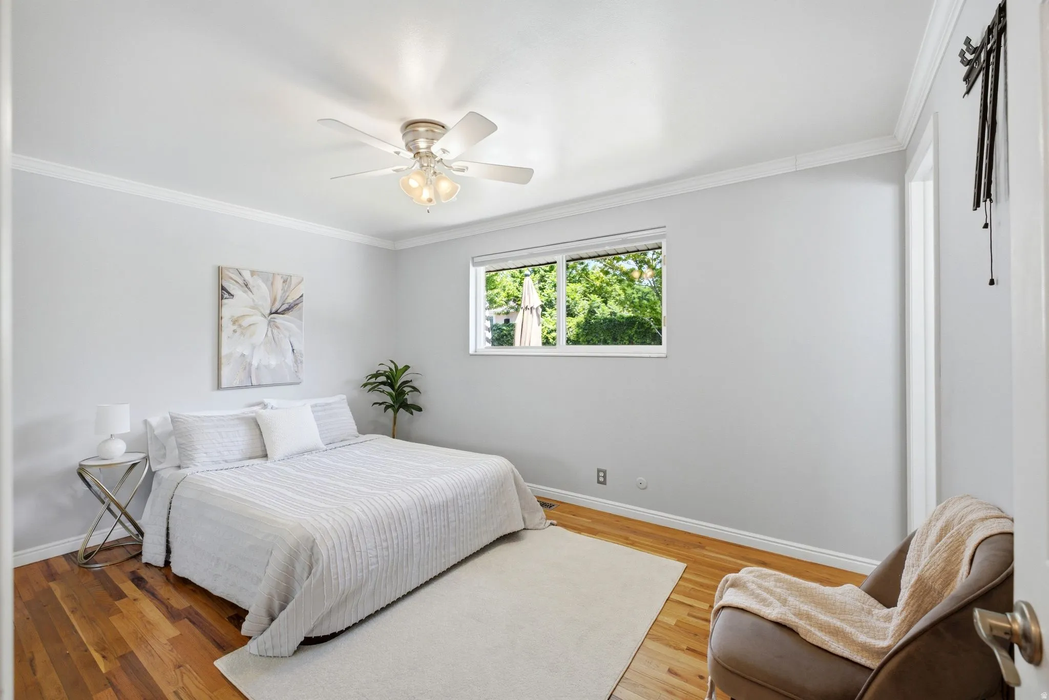 Master Bedroom featuring wood-finish flooring, white walls, and a window with exterior views