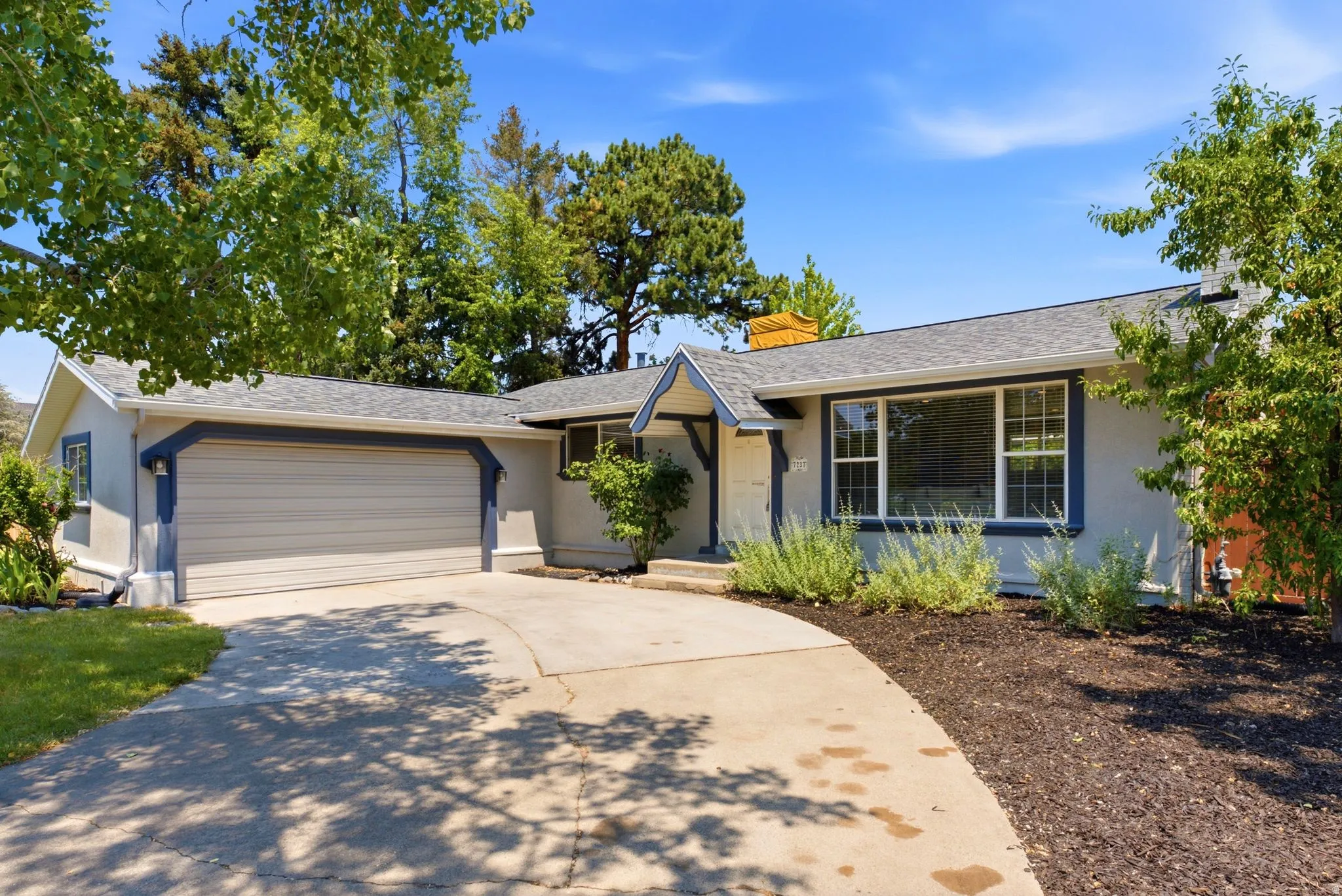 Single-story residence featuring a two-car garage with a concrete driveway