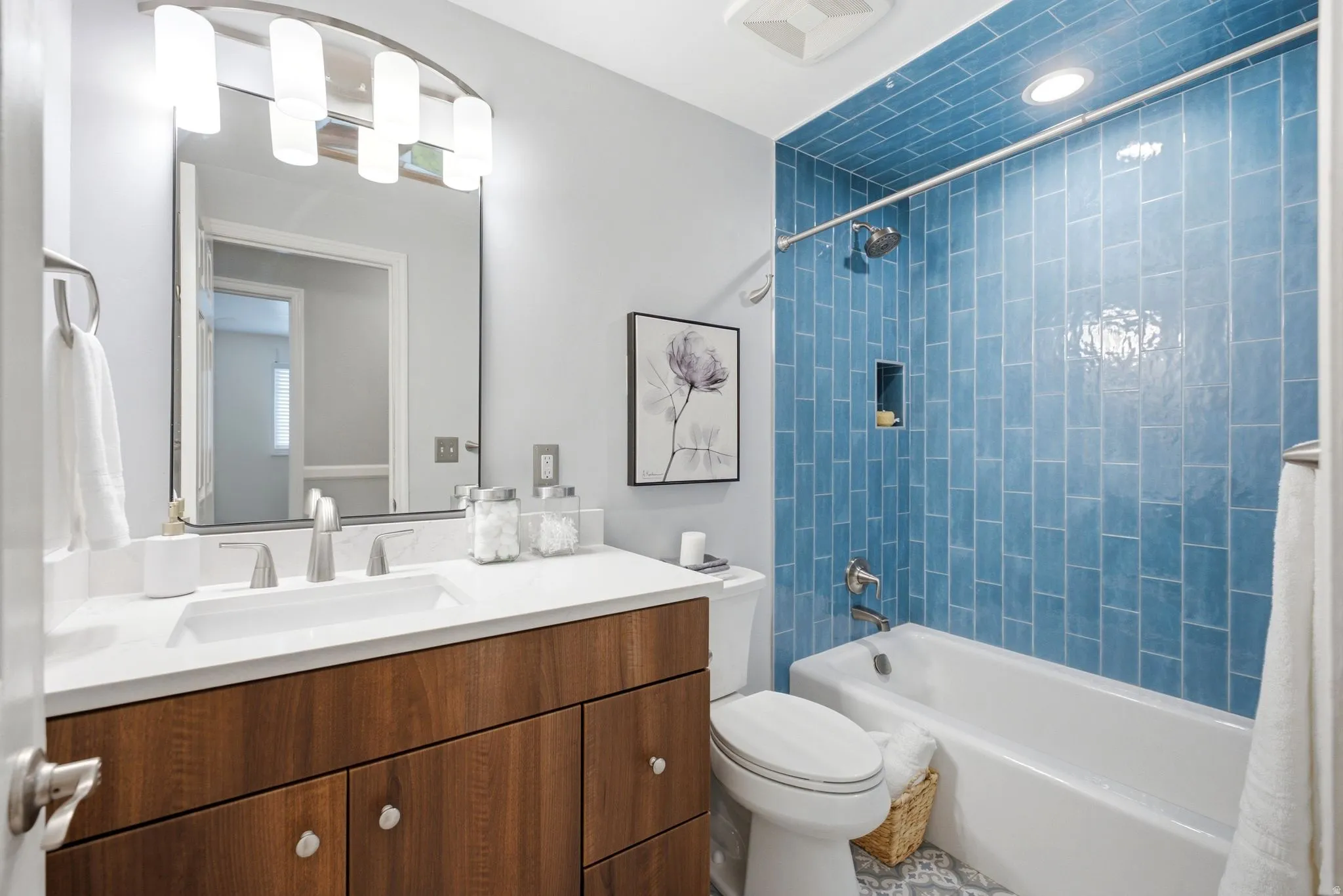 Main level hallway Modern bathroom featuring a wood-finish vanity with a white countertop and rectangular undermount sink
