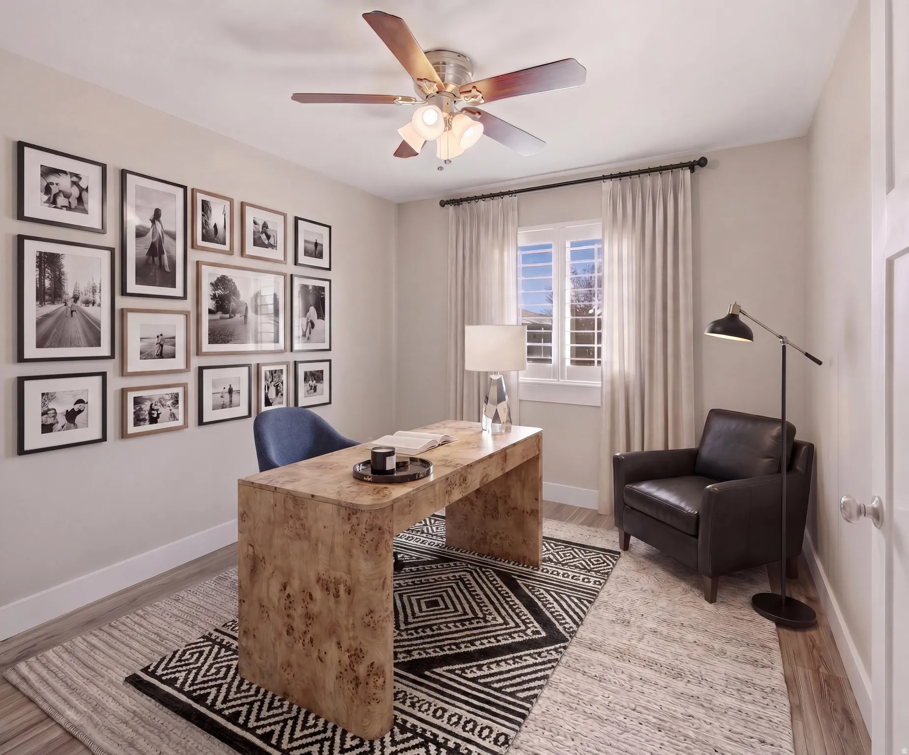 Light-filled room featuring wood-finish flooring, a ceiling fan with integrated lighting, and a window with white shutters