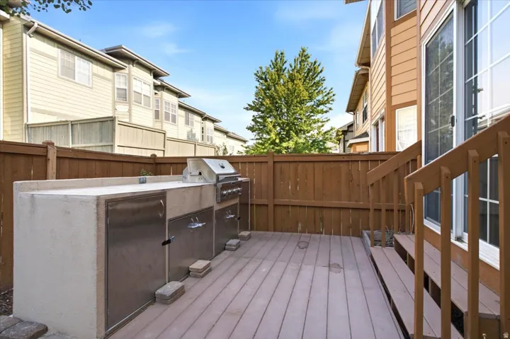 Outdoor deck featuring a built-in grill station with stainless steel cabinetry