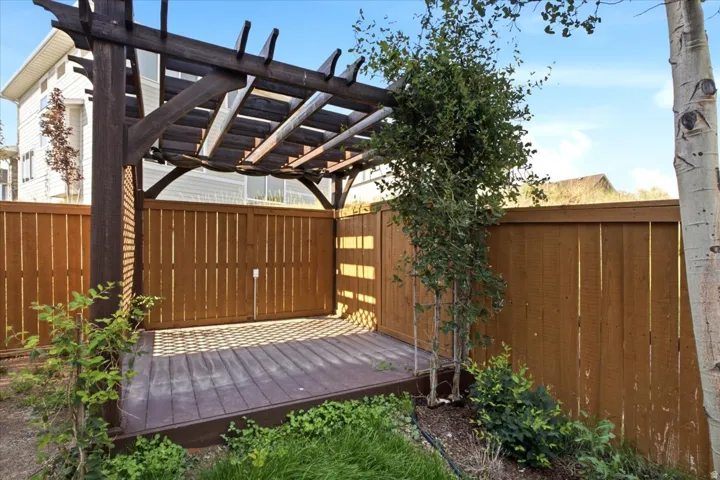 Wood pergola structure over a composite deck