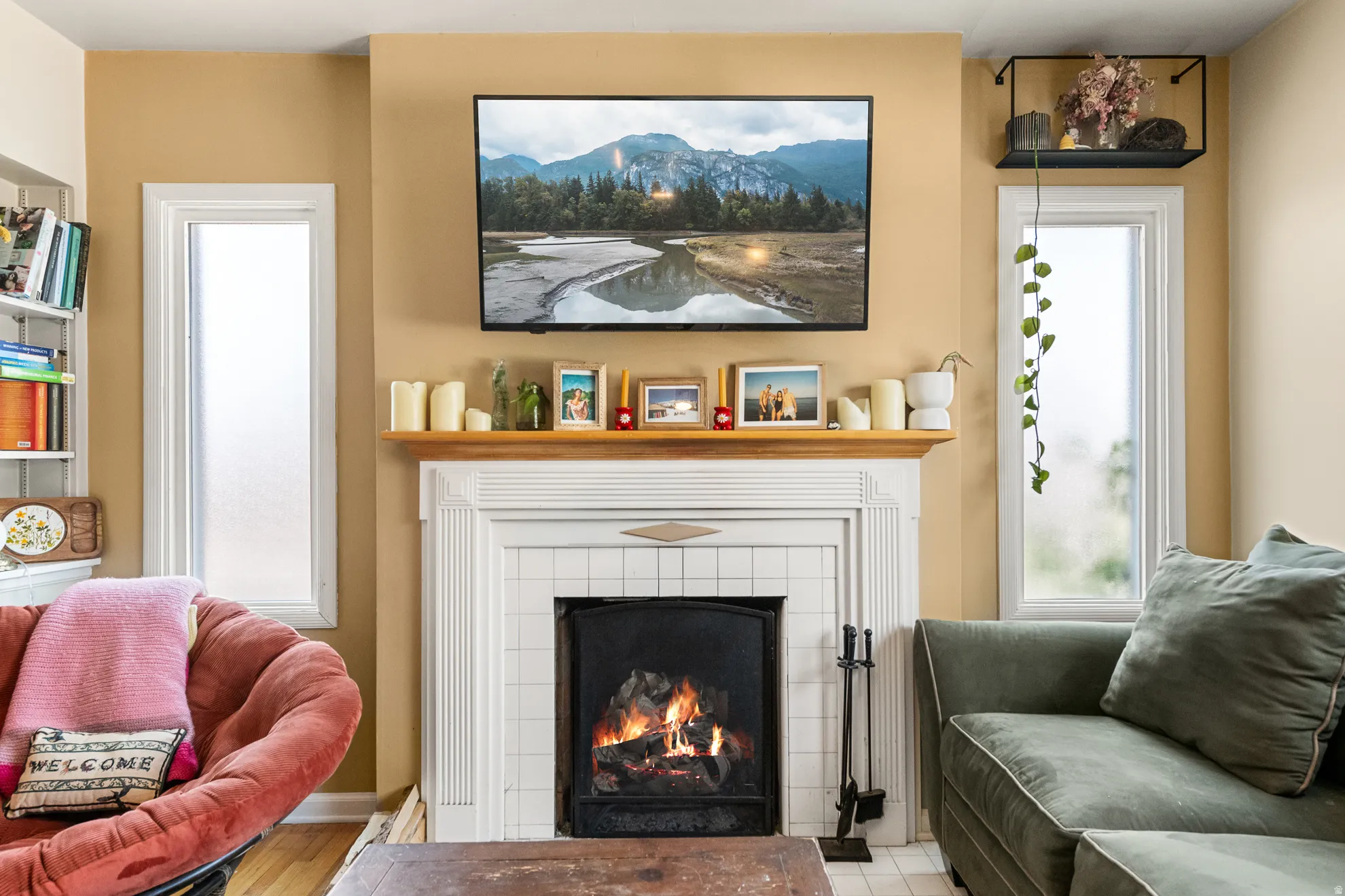 Fireplace featuring white tile surround, detailed mantel, and hearth