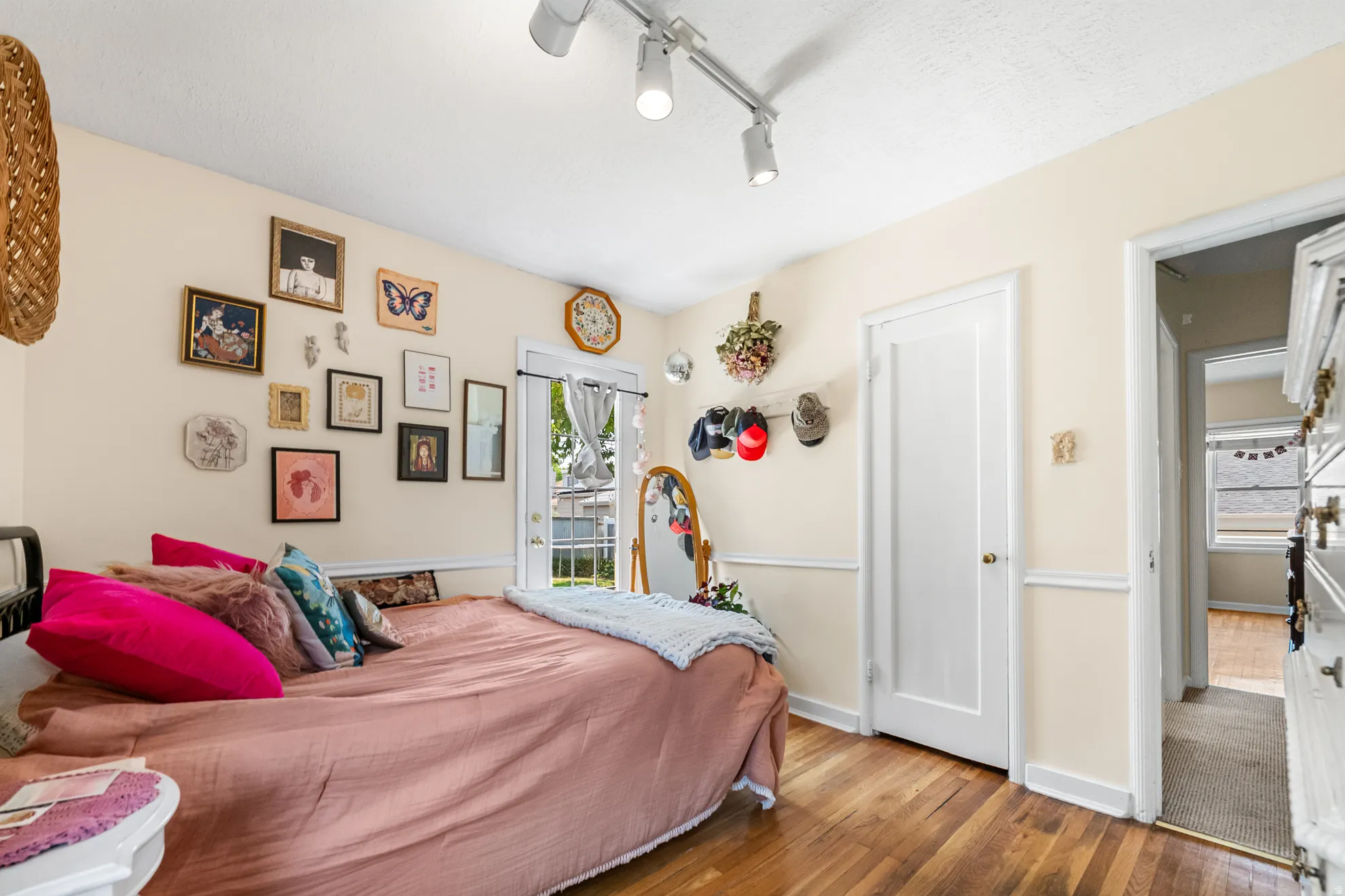 Hardwood flooring extends throughout this room, complemented by a white trim