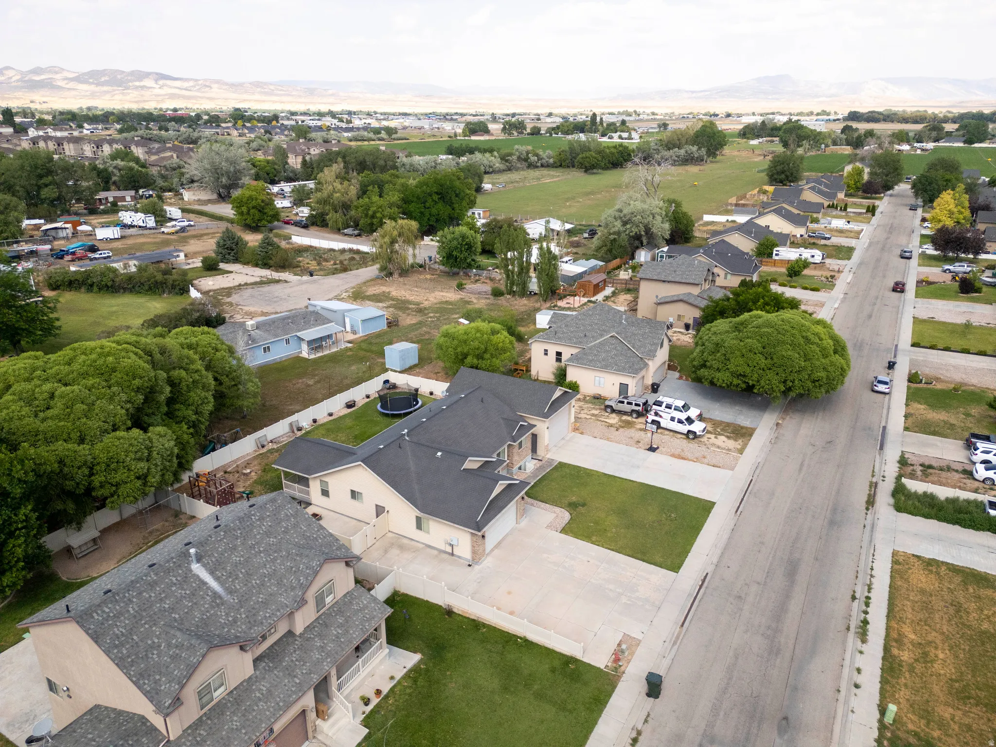 Residential street featuring a collection of properties with varied rooflines and front yards