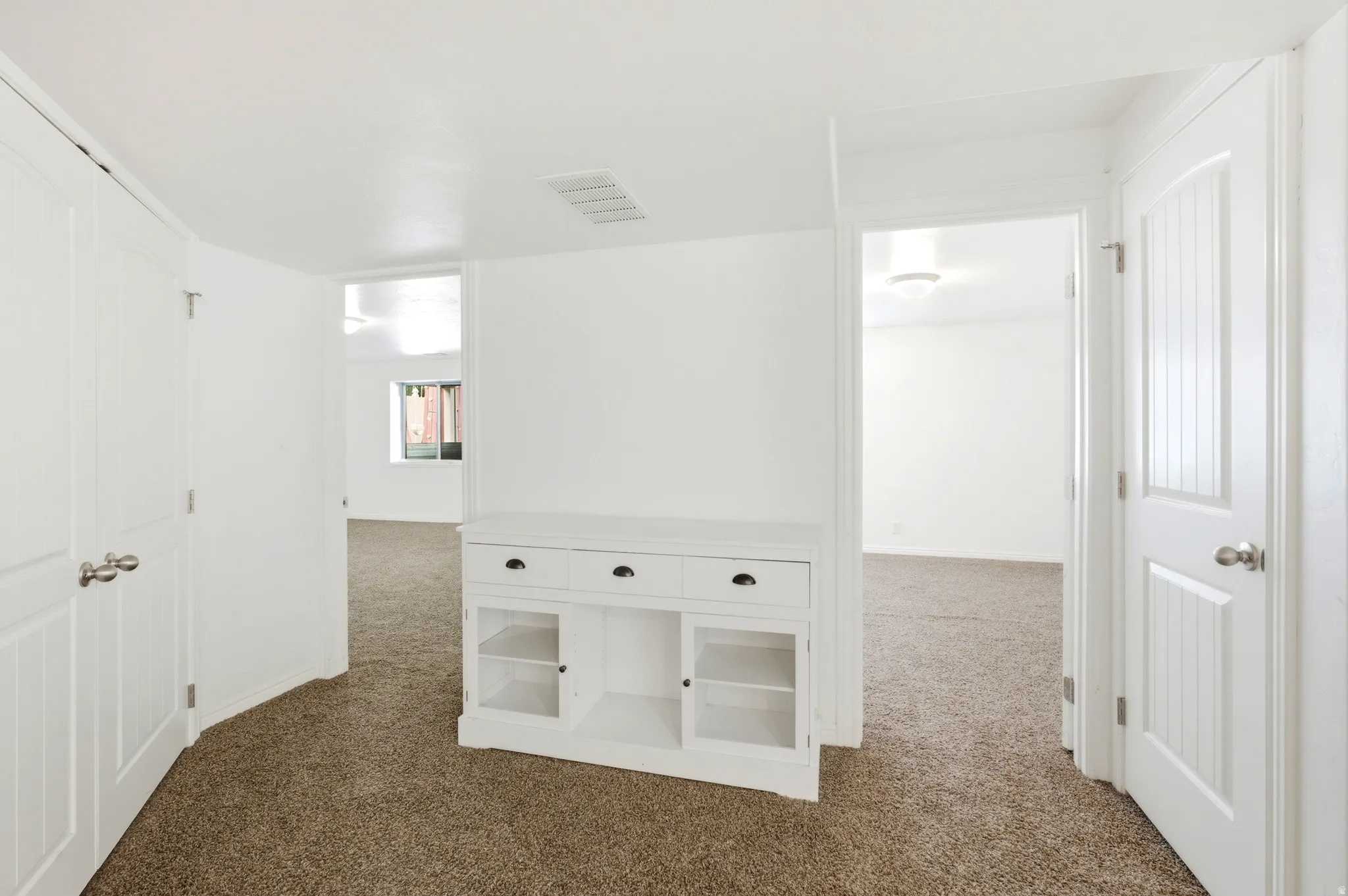 Neutral white walls with textured brown carpeting