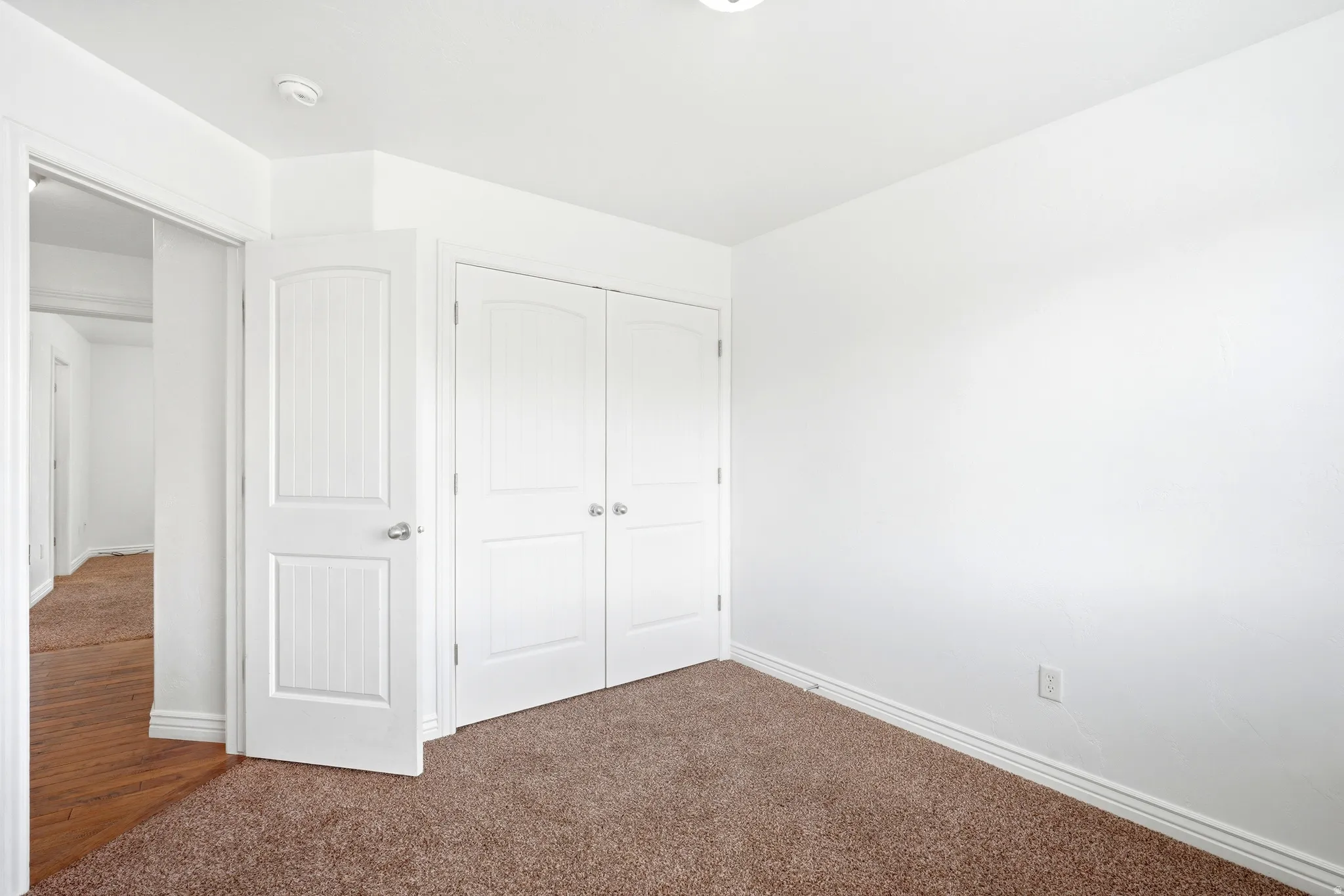 Neutral-toned carpeting and bright white walls