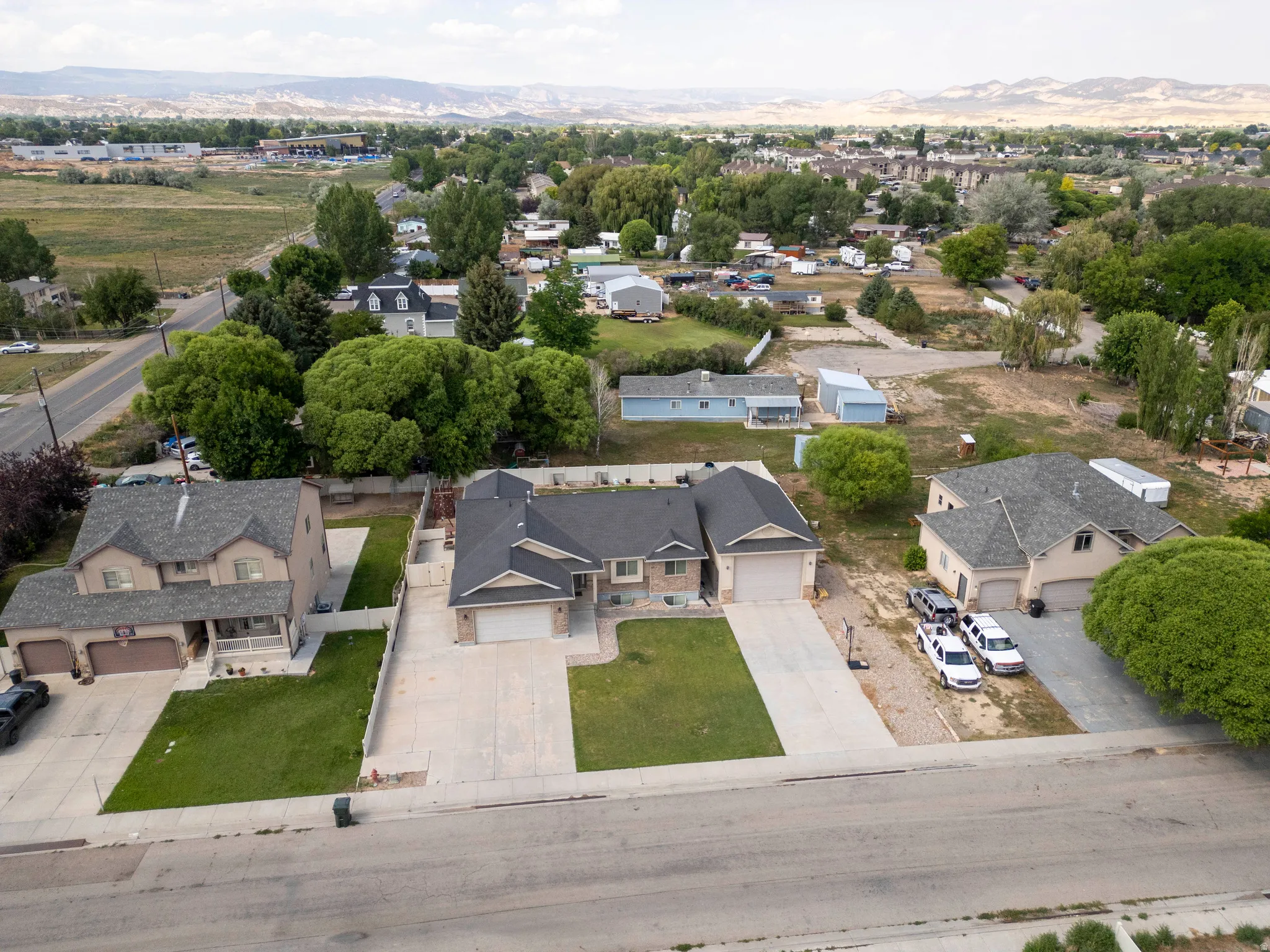 Single-story residence featuring an attached garage, concrete driveway, and a front lawn