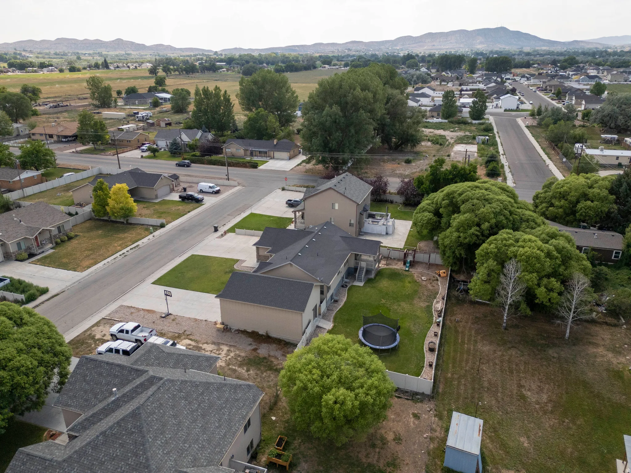 Aerial perspective showcasing a residential area with paved streets and manicured lawns