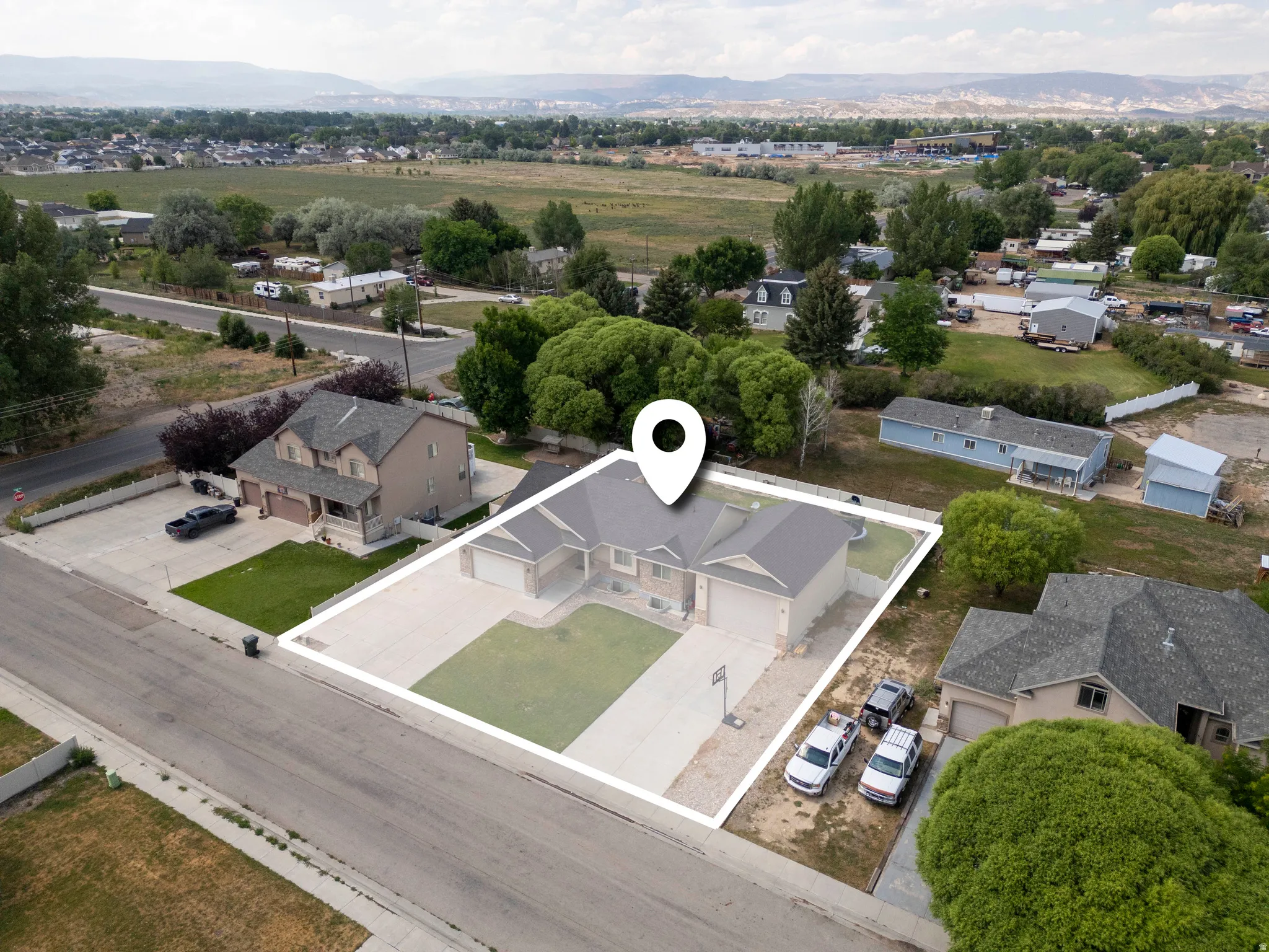 Single-story home featuring an attached two-car garage, concrete driveway, and front lawn