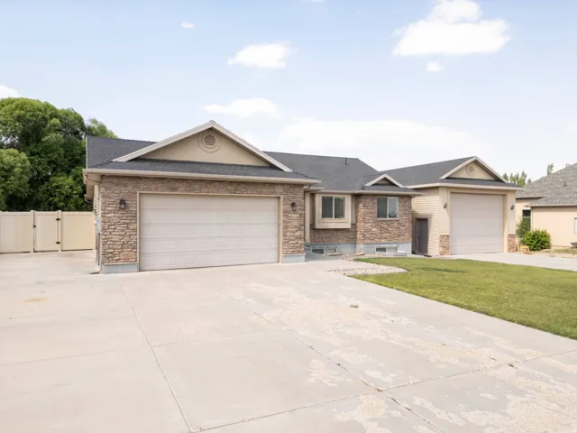 Stone veneer facade with tan siding accents