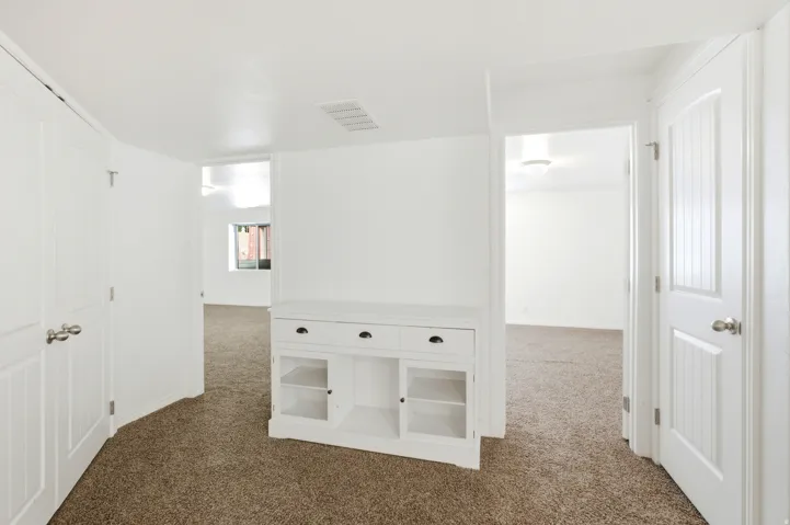 Neutral white walls with textured brown carpeting