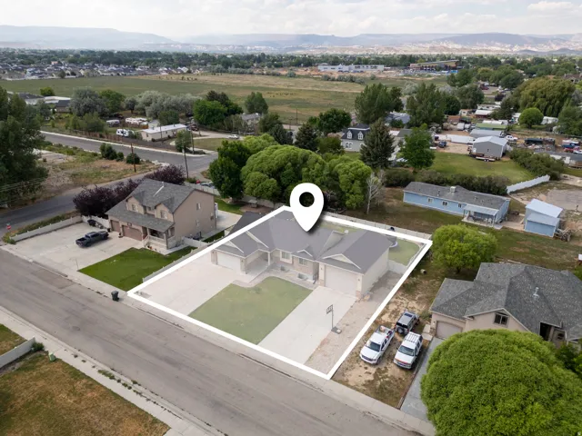 Single-story home featuring an attached two-car garage, concrete driveway, and front lawn