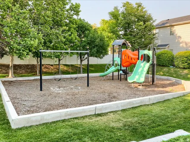 Dedicated play area featuring a swing set and multi-component playground structure