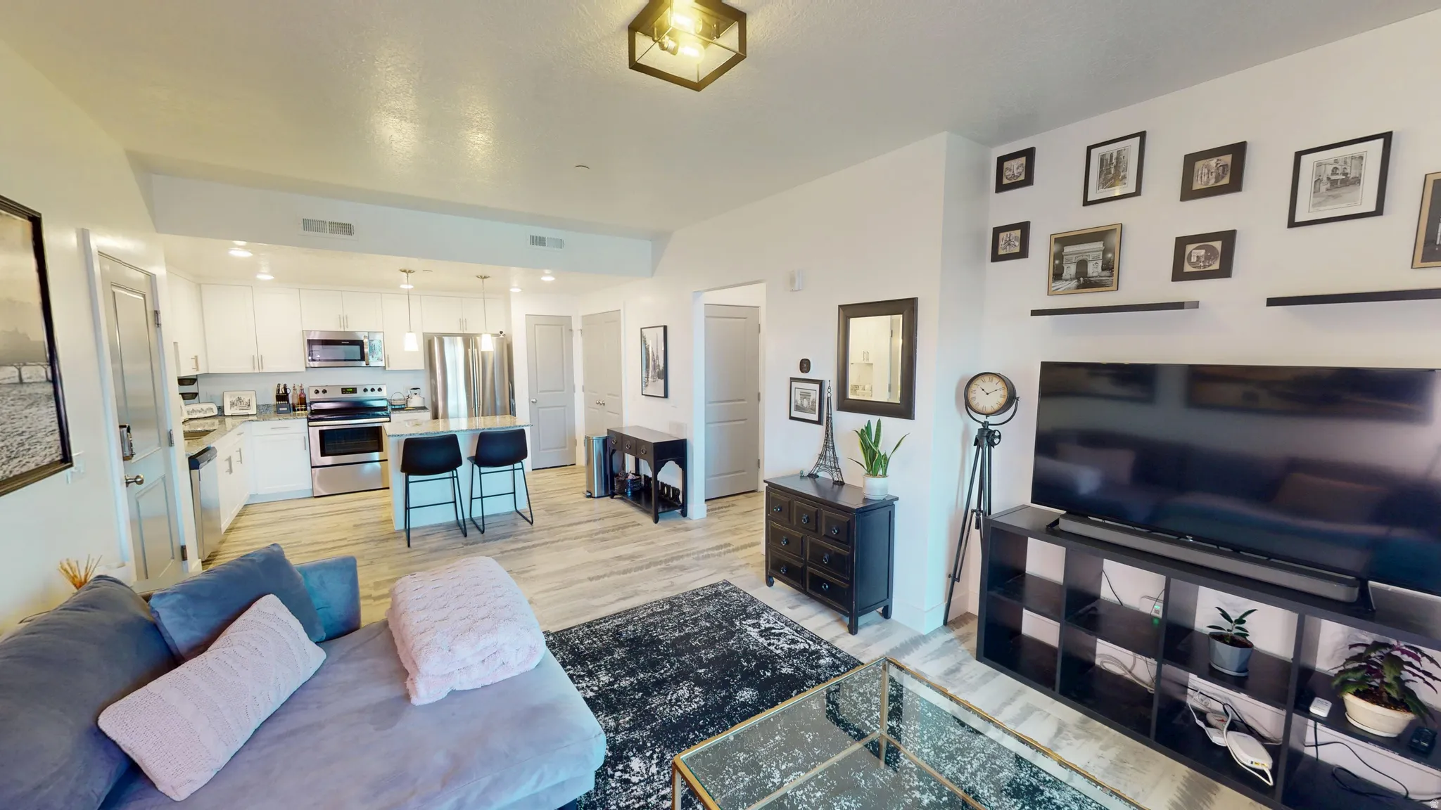 Open-concept living area featuring light wood-finish flooring throughout