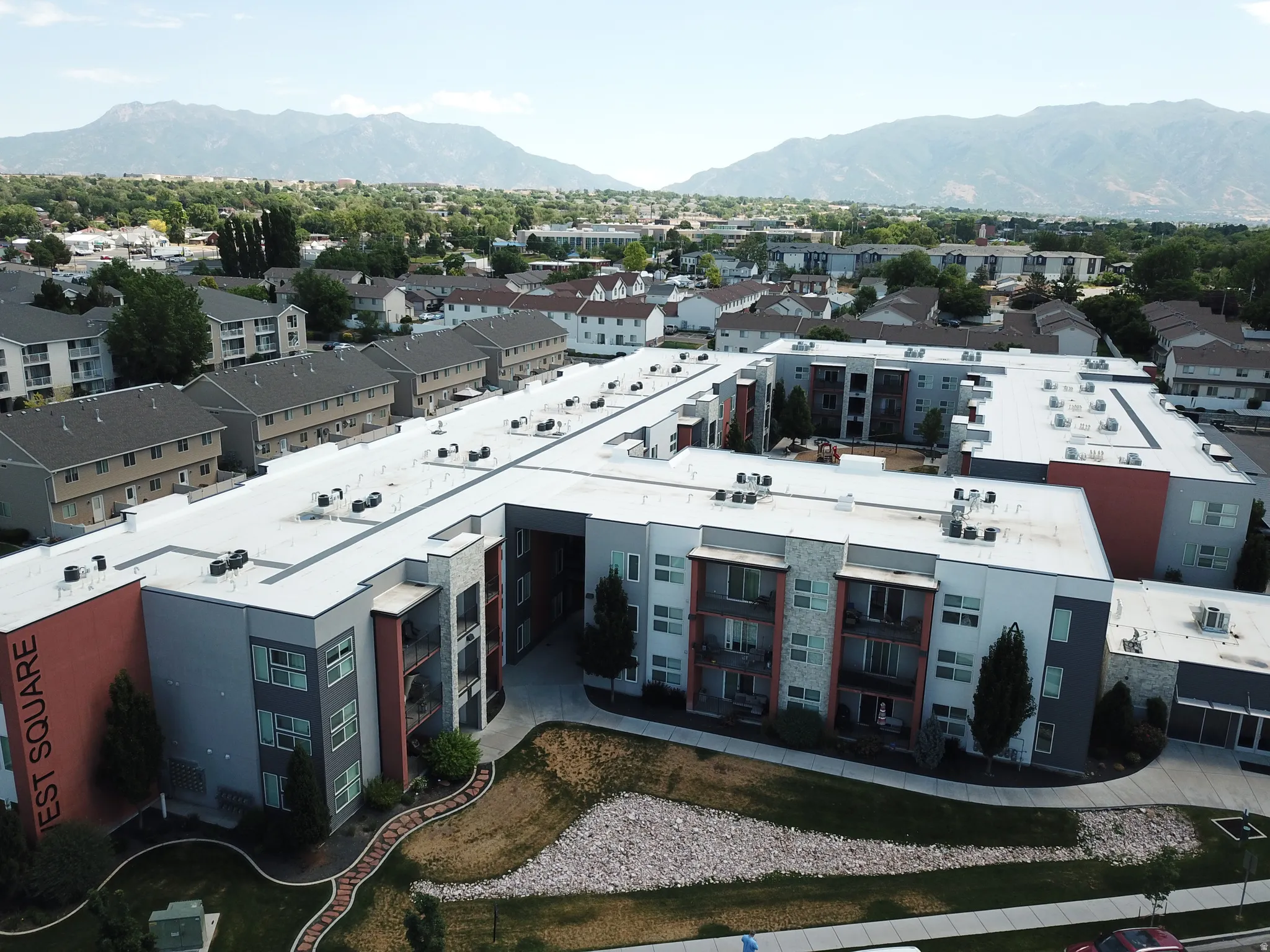 Modern multi-story complex featuring contemporary architecture with varied façade materials