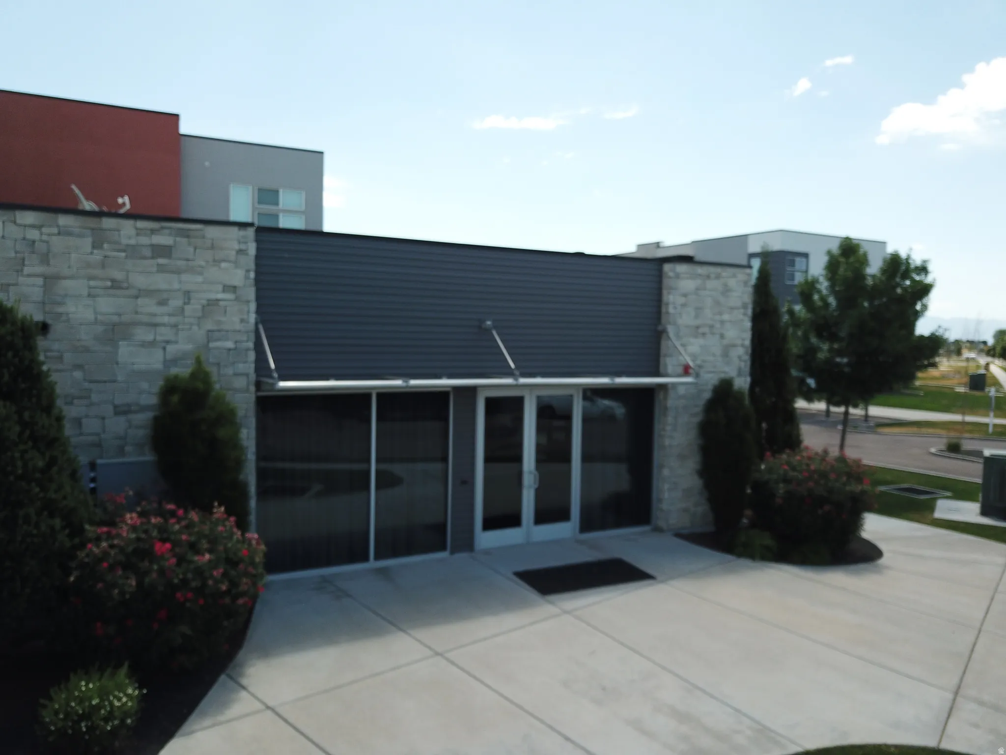 Modern commercial facade featuring a prominent double-door entrance with transom windows