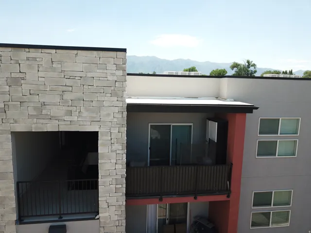 Modern exterior with stone accents and a private balcony