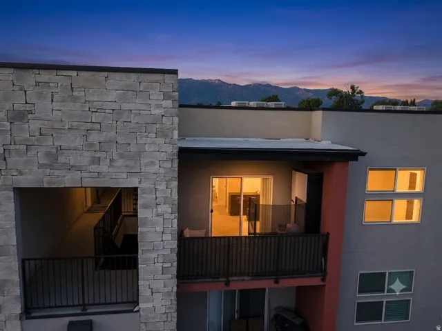 Exterior balcony with black metal railing and glass paneling