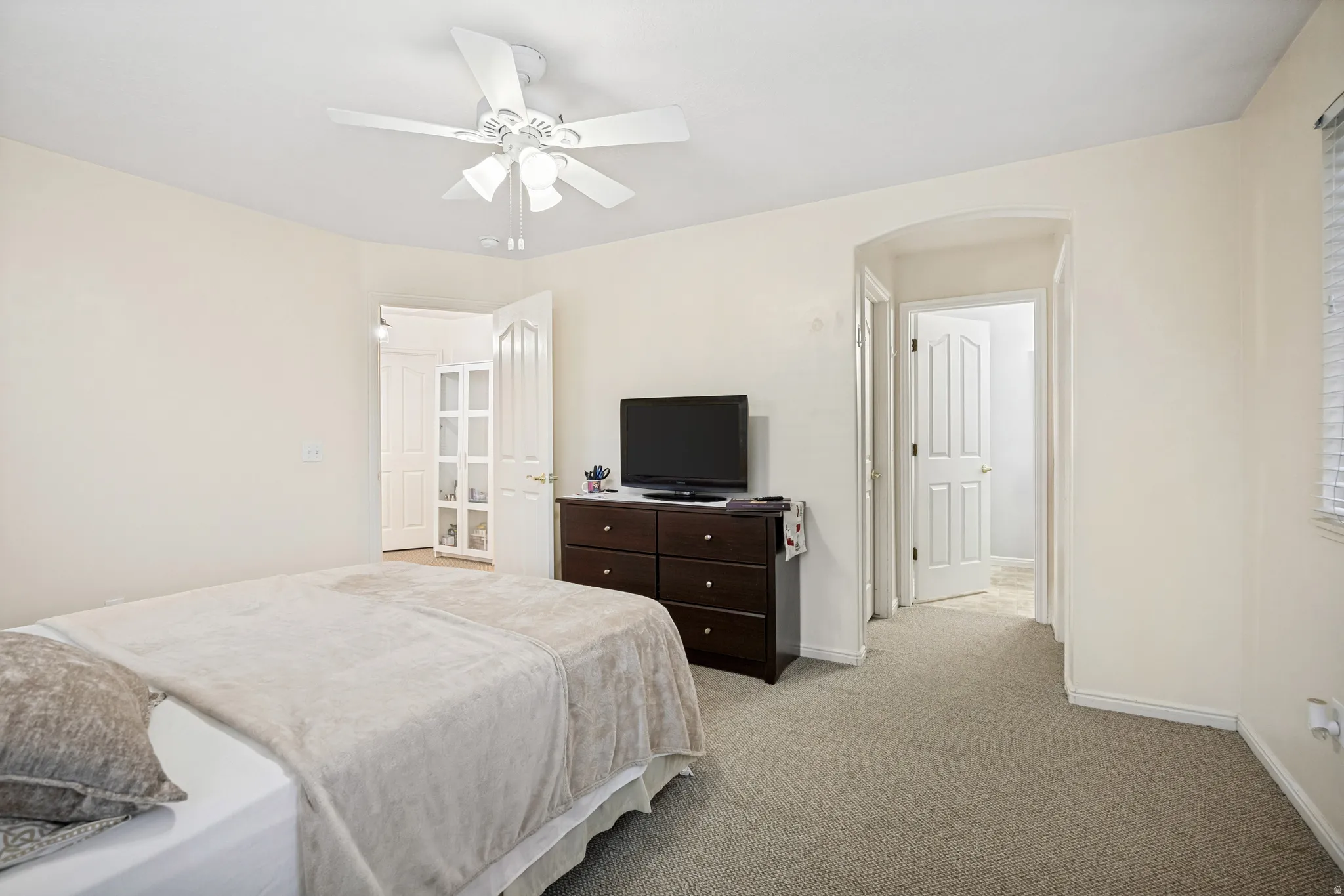Carpeted interior space featuring light neutral walls and white trim