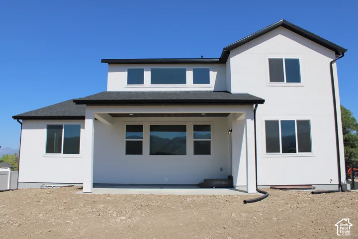 Modern white stucco exterior with black-framed windows