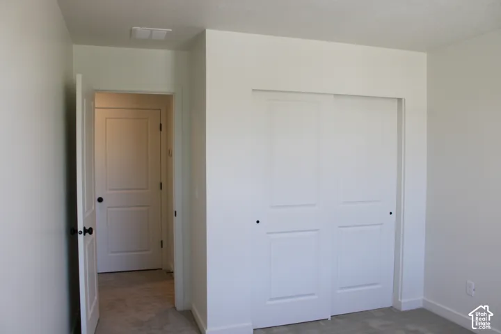 Room featuring neutral wall paint, white trim, and light gray carpet