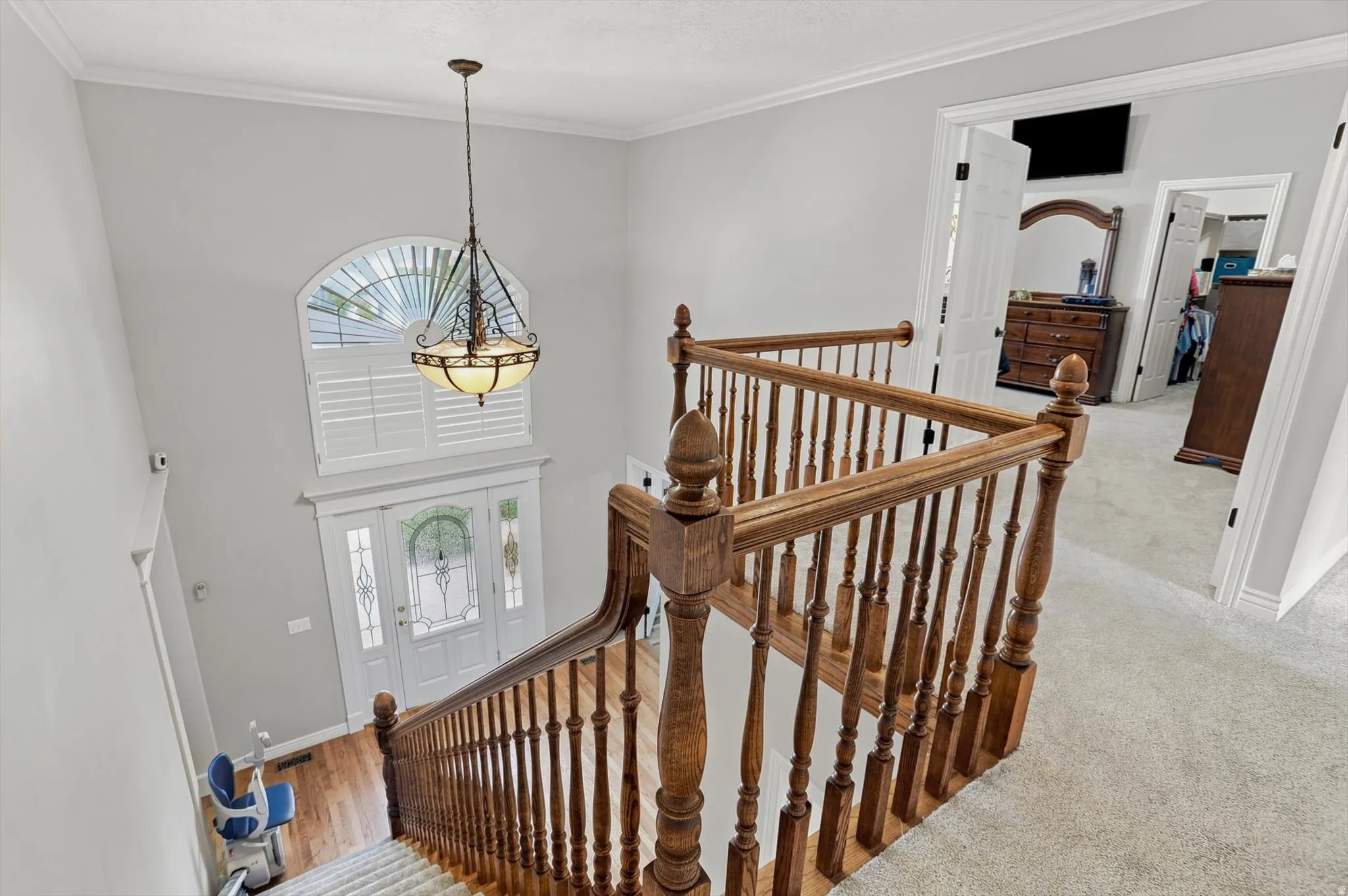 Two-story foyer with a leaded glass entry door and an arched transom window above