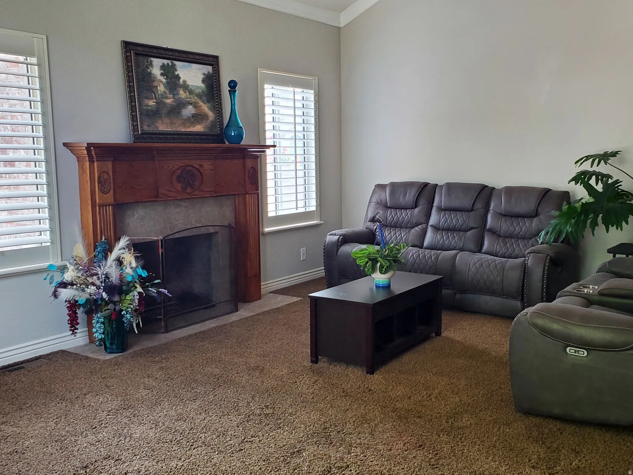 Fireplace featuring an ornate wood-finish mantelpiece, hearth, and metal fire screen
