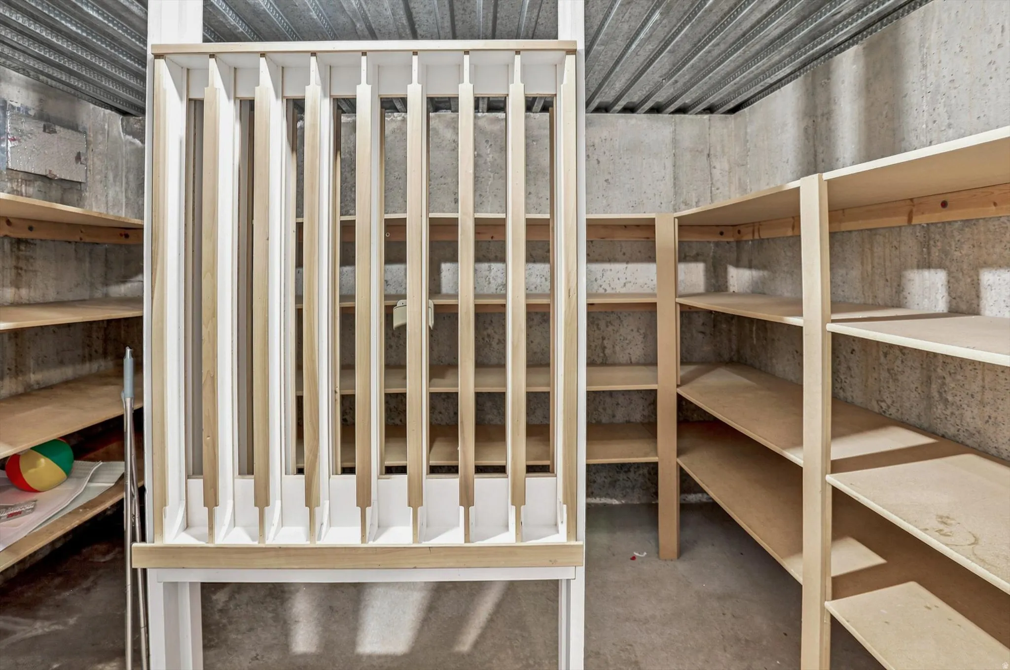 Concrete walls with integrated wooden shelving units